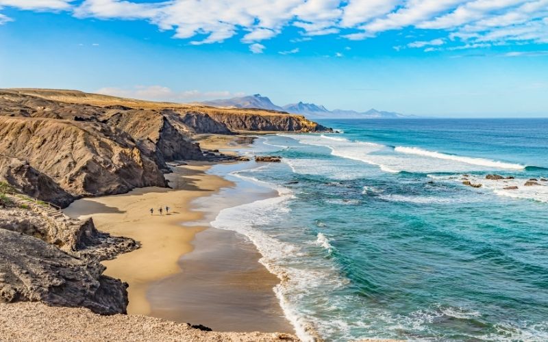 Prachtige kustlijn van Fuerteventura met blauwe zee, spectaculaire kliffen en een goudgeel zandstrand